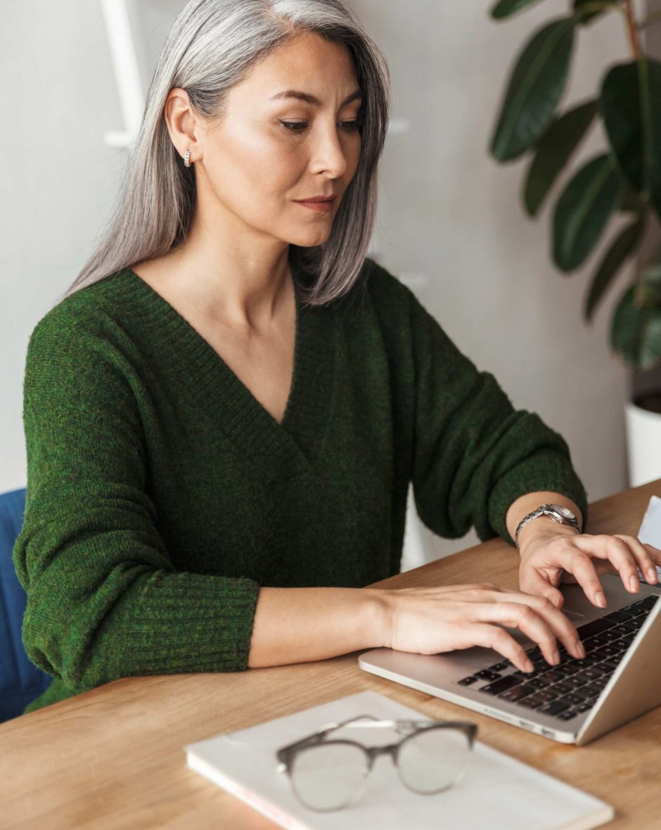 photo-of-gray-haired-focused-businesswoman-typing-MJKPXEZ-scaled.jpg